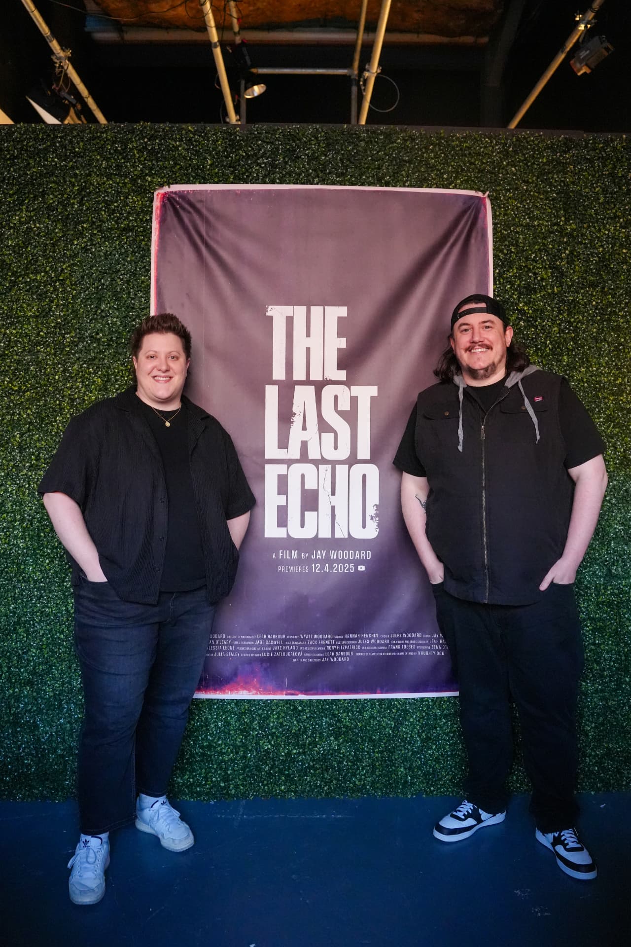 Filmmakers beside The Last Echo poster at the premiere