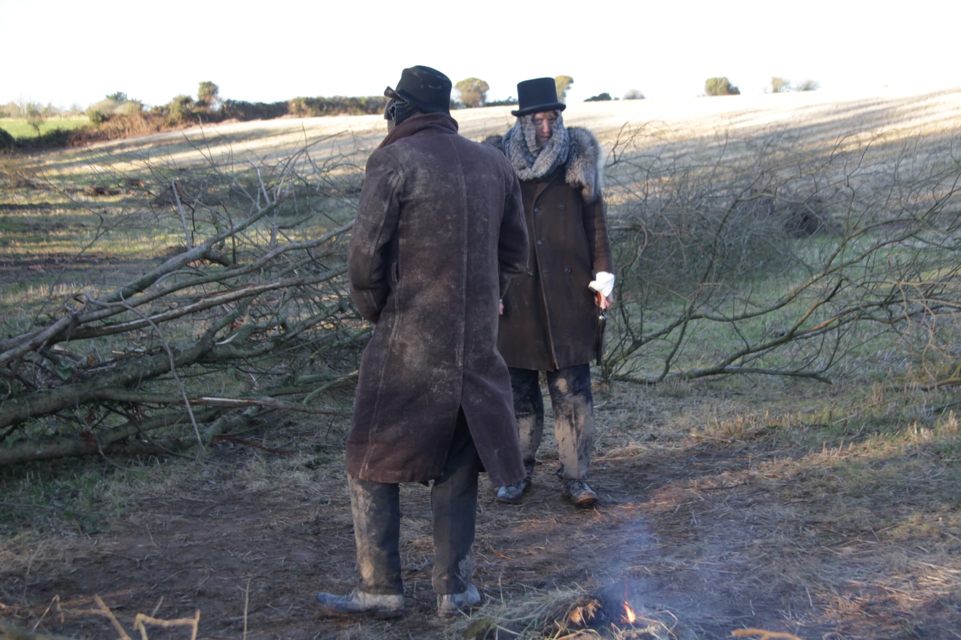 Actors rehearsing beside the campfire set