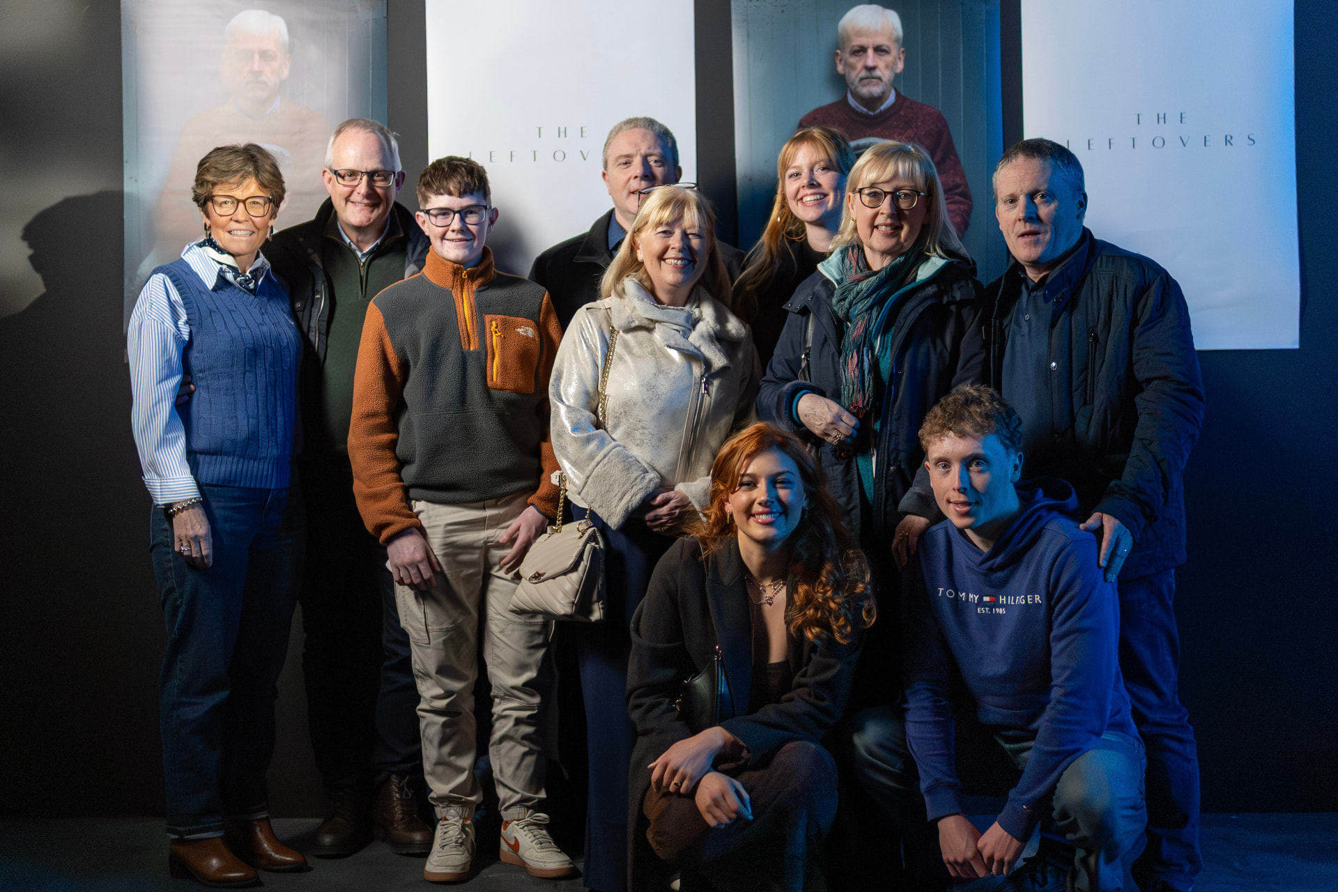 Group photo in front of The Leftovers posters