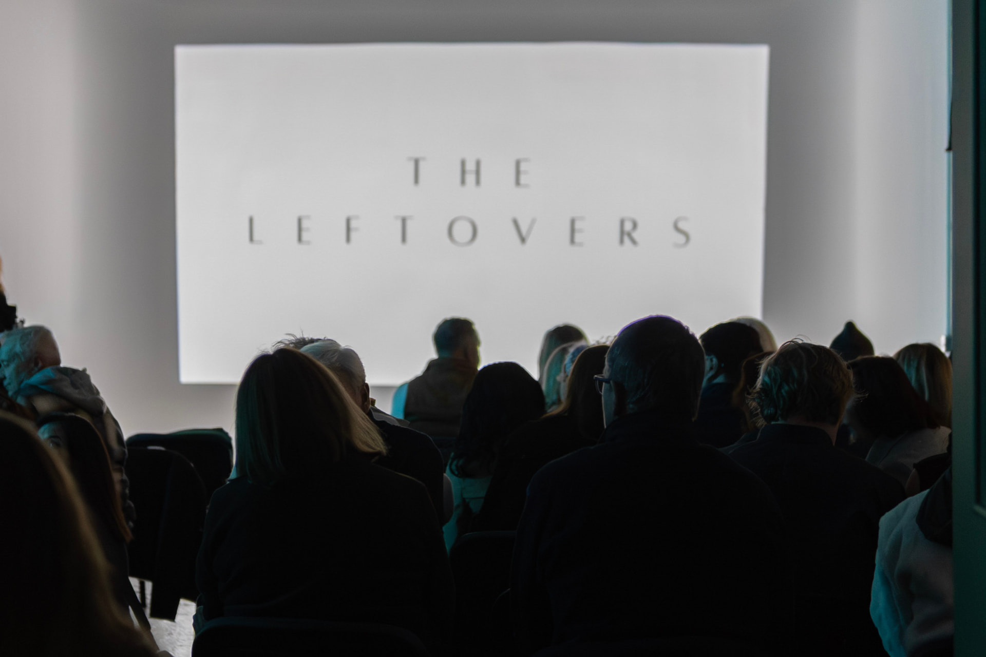 Audience watching The Leftovers title card on screen at the premiere
