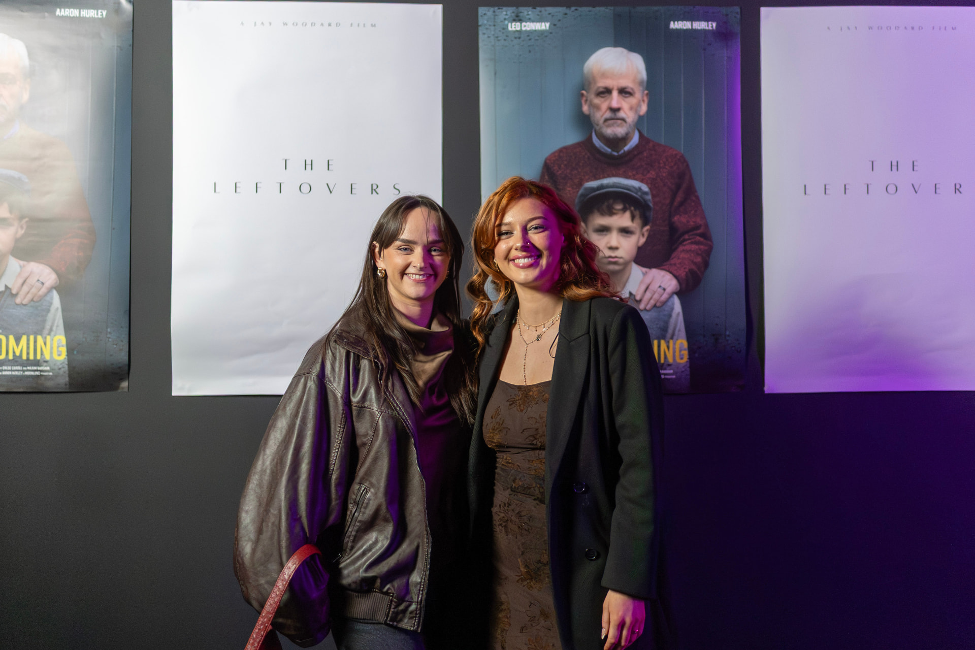 Guests beside The Leftovers poster wall